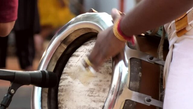 Artist playing Thavil, a South Indian percussion musical instrument	