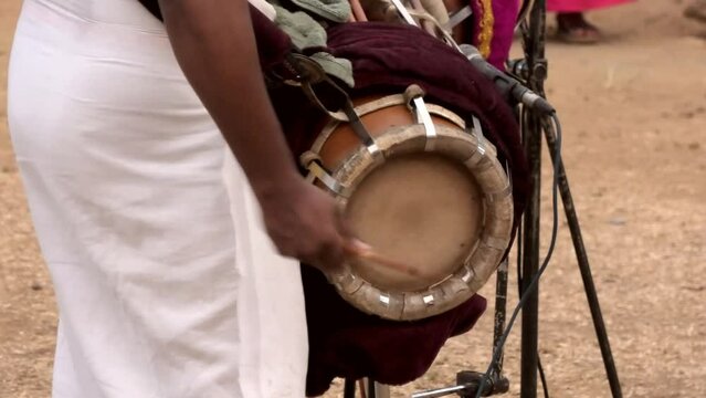 Artist playing Thavil, a South Indian percussion musical instrument	