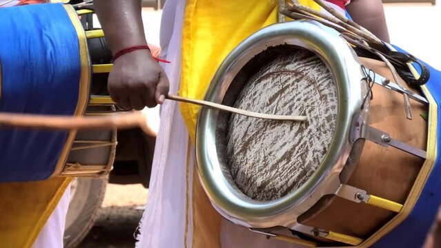 Artist playing Thavil, a South Indian percussion musical instrument	