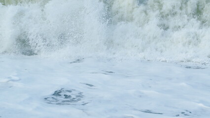 Amazing Water Background At Storm. Big Splash Sea Wave. Dangerous On Beach. Slow motion.