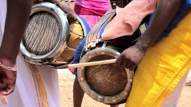 Artist playing Thavil, a South Indian percussion musical instrument	