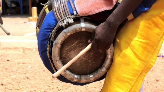 Artist playing Thavil, a South Indian percussion musical instrument	