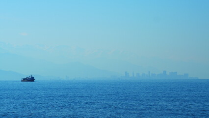 Fishing Boat On The Horizon At Sea. Abstract Small Waves On Calm Water Surface In Motion. Real time.