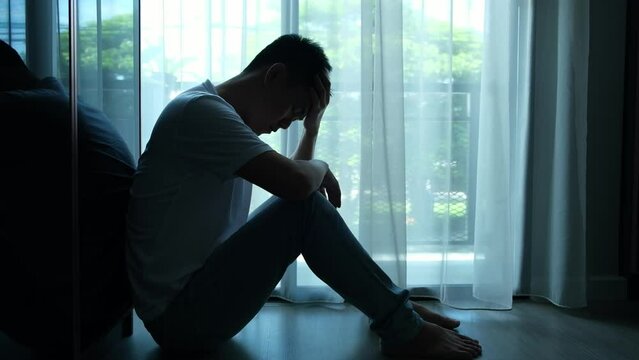 man sitting in the corner of the room have emotional and mental problems He has depression and stress from society and work. medical concept.	