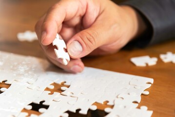 Businessman team work jigsaw. Business Concept.