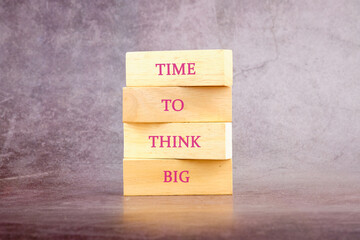 Business and Time to think big concept. Time to think big symbol written on wooden blocks on a dark...