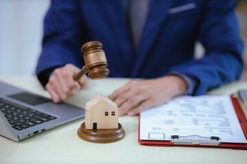 Lawyer sitting in his office On the table with a small hammer judge in court and the scales of...