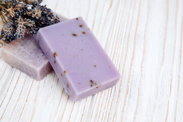 Handmade soap from natural ingredients, various herbs, lavender. Concept of sustainable use, bath product on wooden background. Top view
