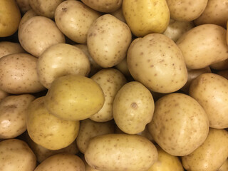 Pile of white potatoes on display at supermarket 