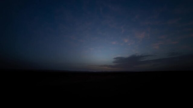 A sunrise timelapse of desert at Mhamid el Ghizlane in Morocco wide shot tilt