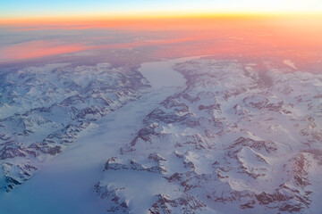 Aerial view of snow mountain and frozen river in colorful morning sunlight in Alaska