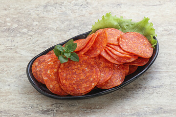 Sliced pepperoni sausage in the bowl