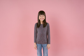 Cute smiling Asian girl feel happy laugh at funny joke and looking at camera in isolated studio...