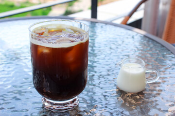 caffe americano and tiny milk jug 
