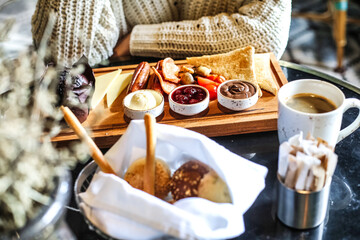 Tray of Food on Table Next to Coffee Cup