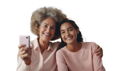 Two generations of women taking selfie, mature woman and young adult smiling on transparent backdrop