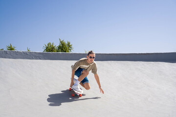 Man Riding Skateboard Down Ramp