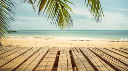 A wooden table facing the sandy beach with a view of the ocean and waves gently crashing