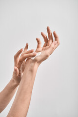 Women's hands apply moisturizer to the skin of the hands