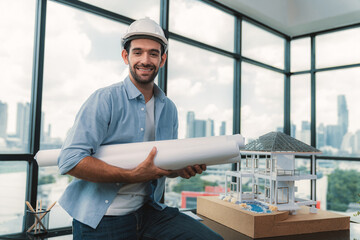 Portrait of professional architect engineer thinking about modern house project while wearing...