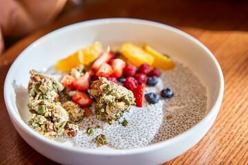 A mixture of strawberries, blueberries, and granola on a plate