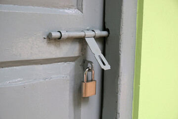 old metal lock on the wooden door.