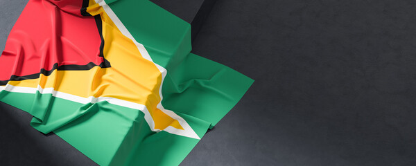 Flag of Guyana. Fabric textured Guyana flag isolated on dark background. 3D illustration
