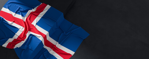 Flag of Iceland. Fabric textured Iceland flag isolated on dark background. 3D illustration
