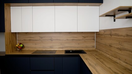 Dark blue kitchen interior with kitchen shelves, utensils. Modern dark blue kitchen.