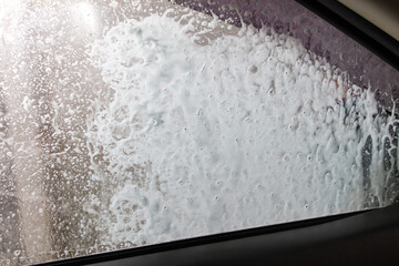 Car glass at a car wash In drops of water. Background