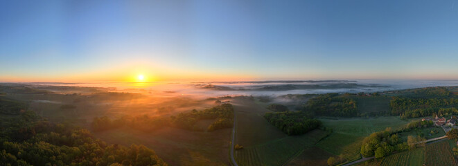 Aerial view of Bordeaux vineyard at sunrise spring under fog, Rions, Gironde, France. High quality...