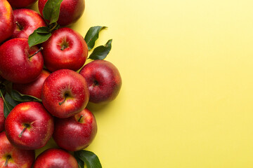 Many red apples on colored background, top view. Autumn pattern with fresh apple above view with copy space for design or text