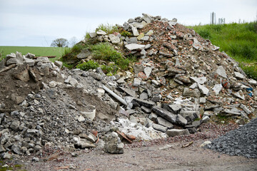 a large pile of building rubble with remains of stones and asphalt