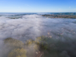 Obraz premium Aerial view of Bordeaux vineyard at sunrise spring under fog, Loupiac, Gironde, France. High quality photo