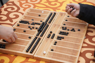The national Kazakh logic board game. Togyz Kumalak.