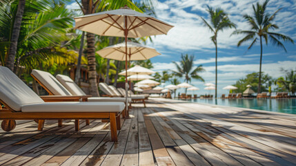 wooden sunbeds with white umbrellas by the pool in front of an island hotel
