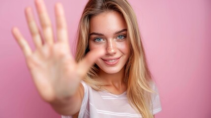 Fototapeta premium A woman with blonde hair and blue eyes is smiling and waving at the camera