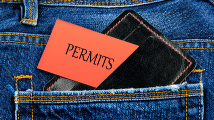 A word PERMITS on business cards from a purse from a jeans pocket