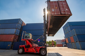 Forklift truck handling cargo shipping container box in logistic shipping yard with cargo container...