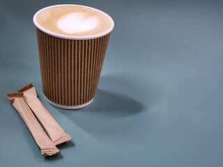Coffee in a paper cup. Paper cup with coffee and sugar
