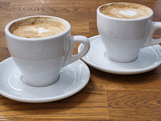 Coffee in white cups. Two white cups with coffee