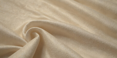 A light colored fabric with a pattern of waves. The fabric is smooth and silky. The waves are small and spaced out