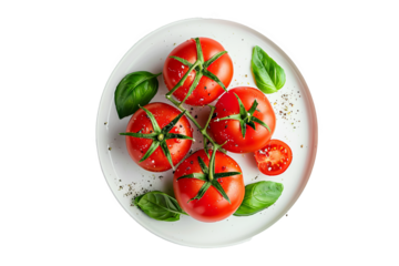 tomatoes with basil leaves on a white plate, isolated on white, top view.