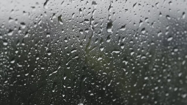 Water drops hitting the glass on a rainy day