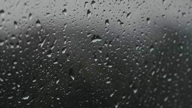 Water drops hitting the glass on a rainy day