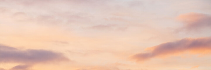 Beautiful sunset sky background with clouds. Scenic cloudscape. Wide panoramic background for...