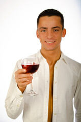 A young attractive man drinks red wine.