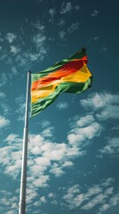 Lithuania flag on a flagpole against a blue sky