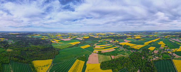 Aerial view of landscape with yellow rapeseed fields. Nature background with patchwork view of...