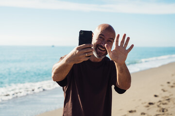 Man taking a picture with his phone. cheerful man takes pictures on his phone. positive emotion and...